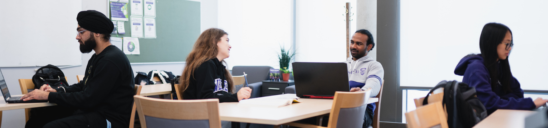 Several student peer leaders sit in a classroom.